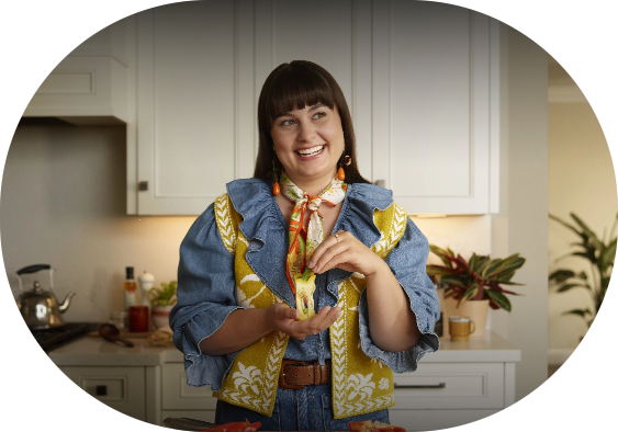 A woman smiling in her kitchen